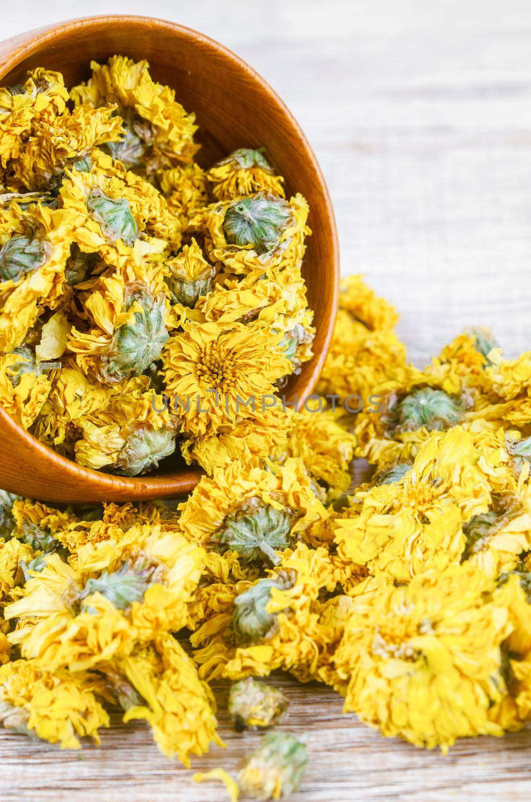 The Dried Chrysanthemum tea in wooden bowl.