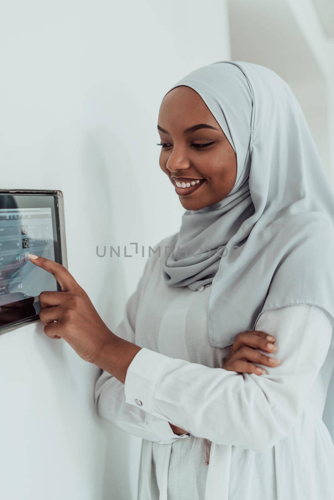 African woman using a smart home screen control system. High-quality photo