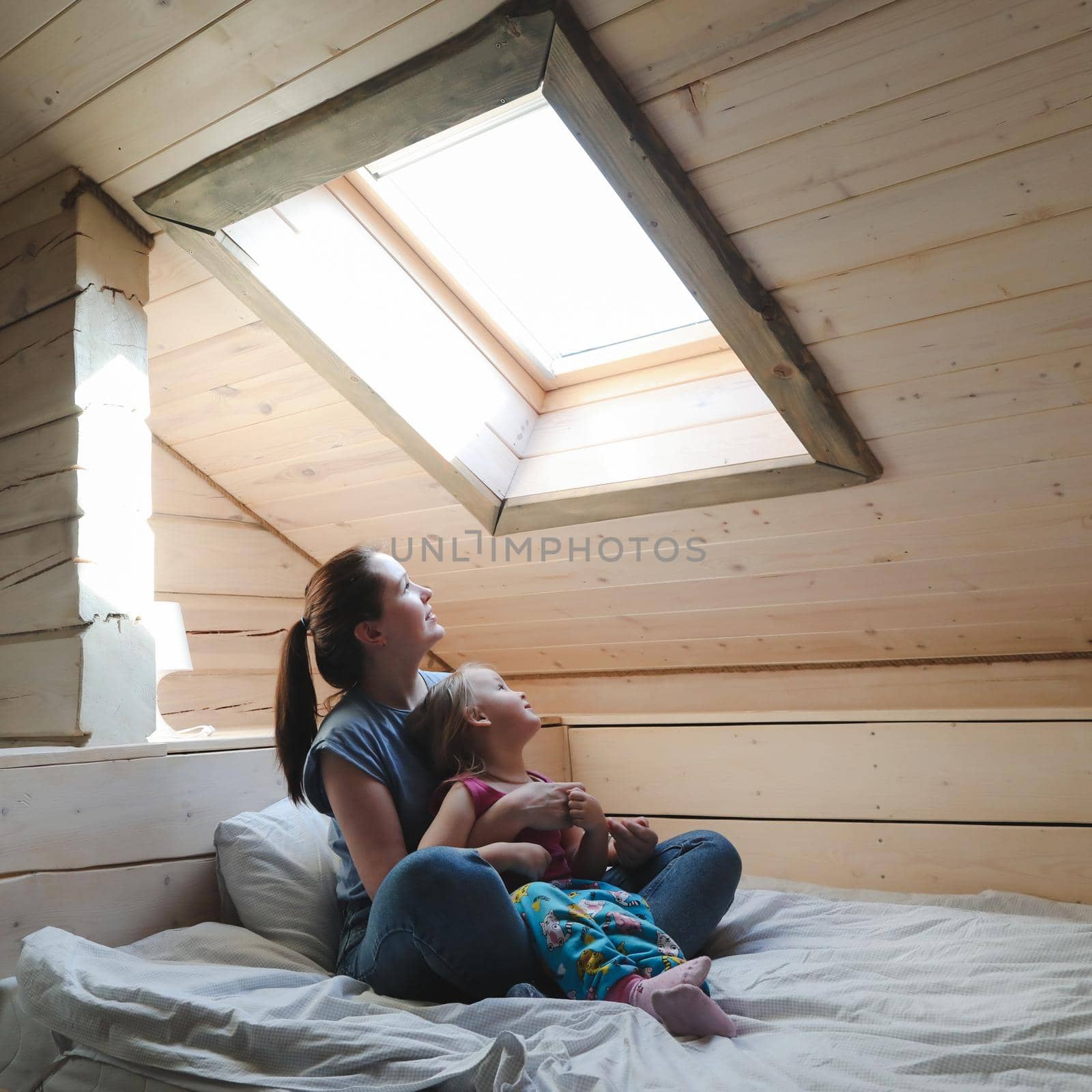 Portrait of enjoy happy family mother and little girl hugging, smiling, playing and having good time in a cozy room at home