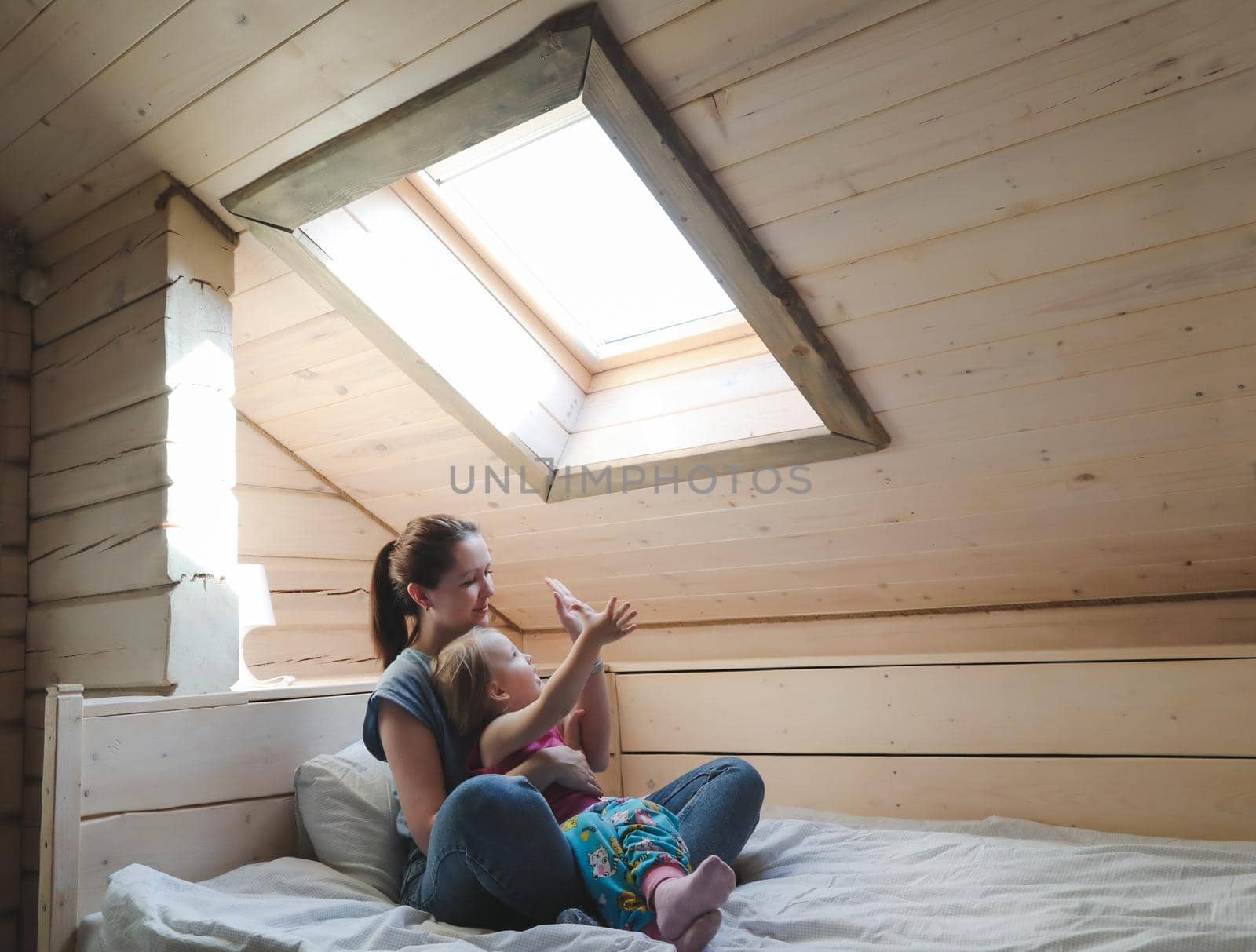 Portrait of enjoy happy family mother and little girl hugging, smiling, playing and having good time in a cozy room at home