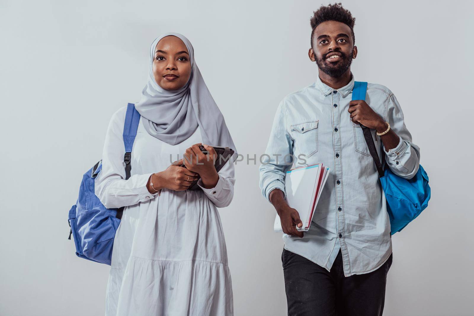 Young African students couple walking woman wearing traditional Sudan Muslim hijab clothes business team isolated on white background.