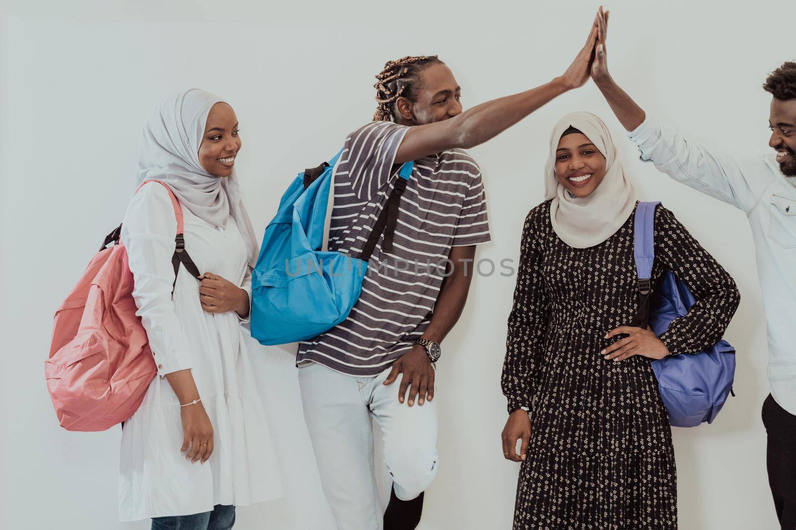 photo of a group of happy African students talking and meeting together working on homework girls wearing traditional Sudanese Muslim hijab. High-quality photo