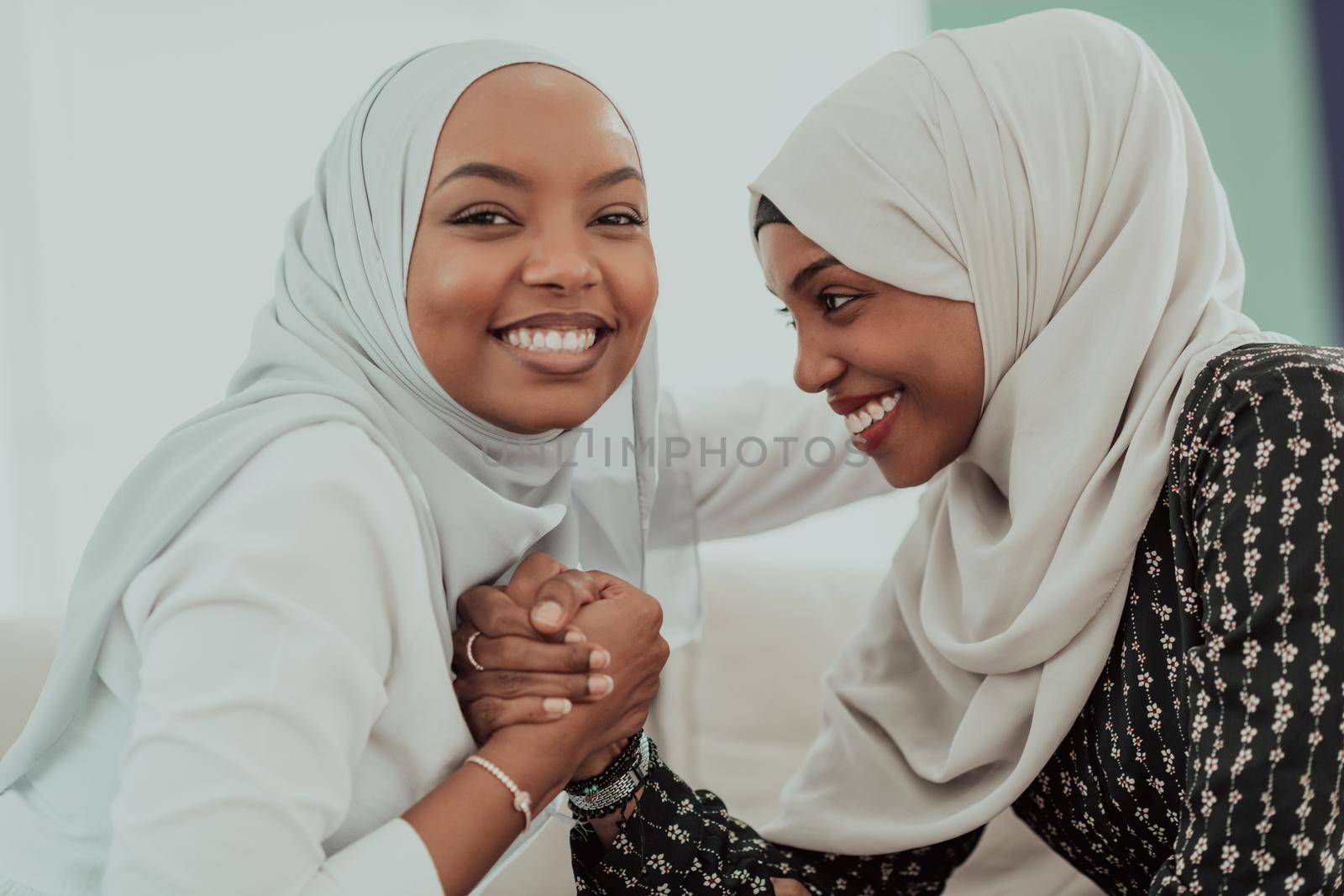 African woman arm wrestling conflict concept, disagreement and confrontation wearing traditional islamic hijab clothes. Selective focus by dotshock