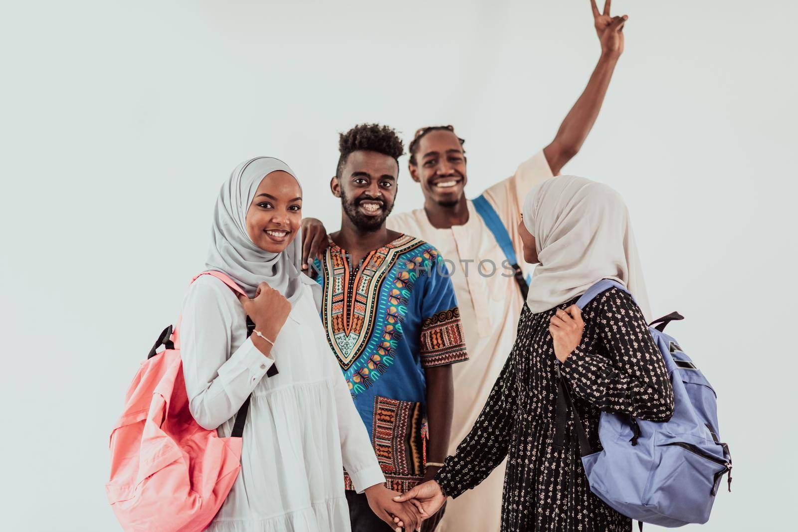 Group of happy african students having conversation and team meeting working together on homework girls wearing traidiional sudan muslim hijab fashion by dotshock