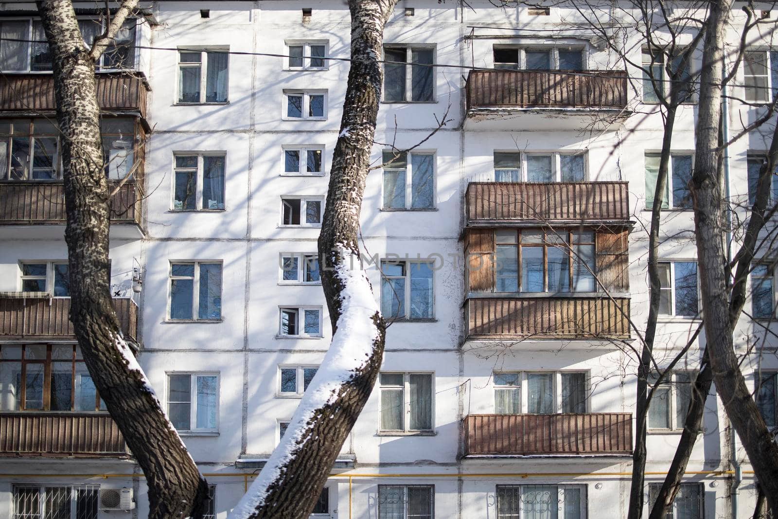 Five-storey block buildings with balconies in the Preobrazhenskaya square, built in the sixties, in good winter weather. by elenarostunova