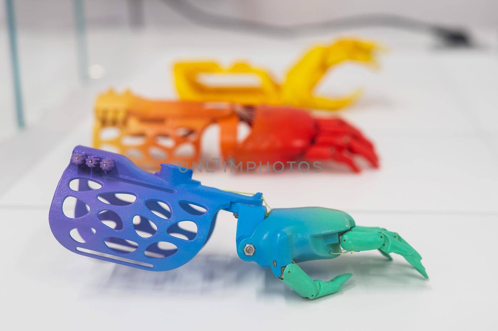 Samples of multi-colored children's prosthetic hands made of 3D plastic