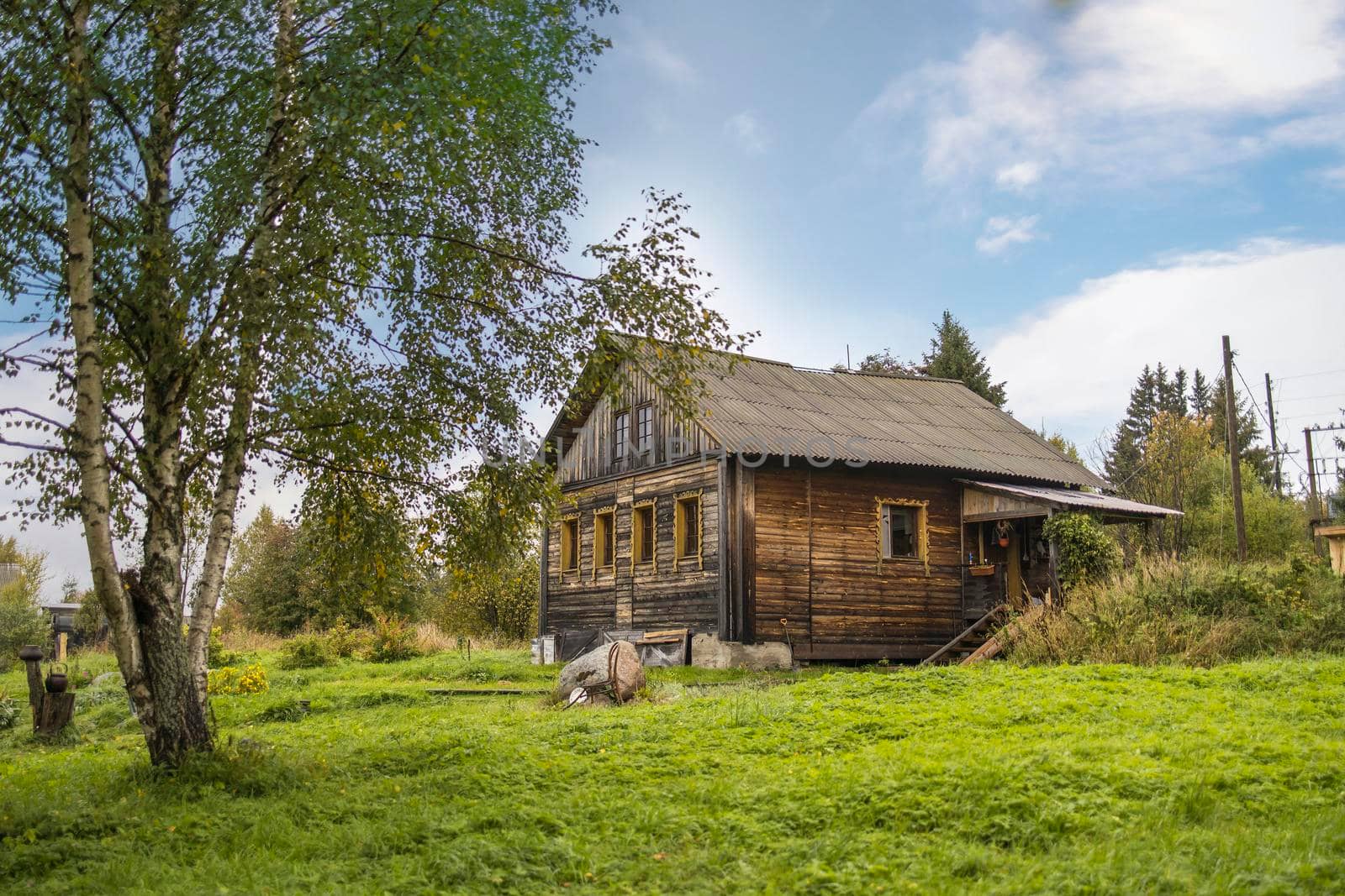 Karelia, Russia - 20 September 2021, Wooden house with a barn near the national reserve "Ladoga Skerries" in Karelia on the border with Finland by elenarostunova