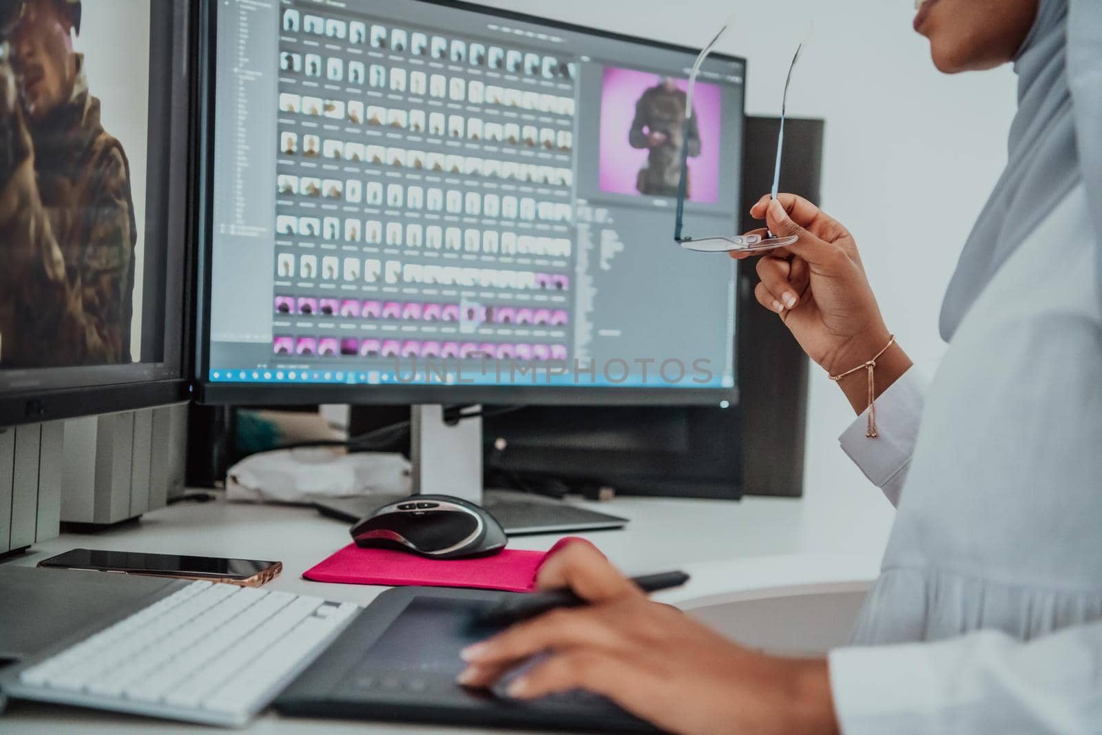 Young Afro-American modern Muslim businesswoman wearing a scarf in a creative bright office workplace with a big screen. by dotshock