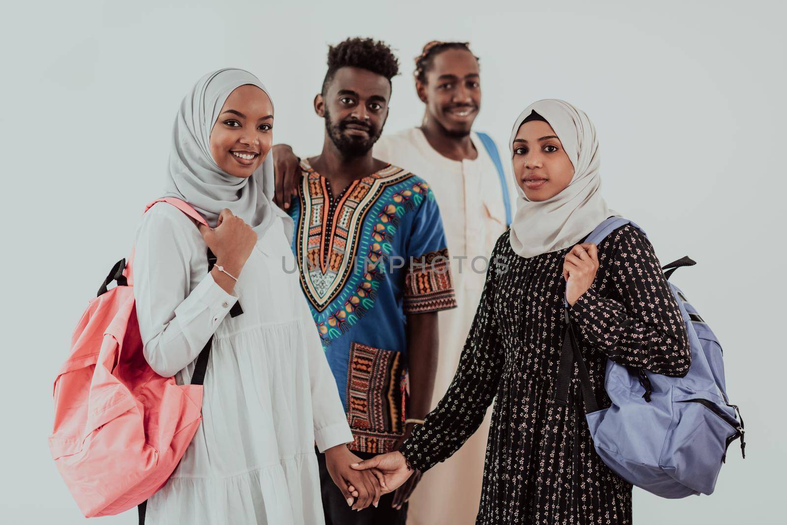 Group of happy african students having conversation and team meeting working together on homework girls wearing traidiional sudan muslim hijab fashion by dotshock