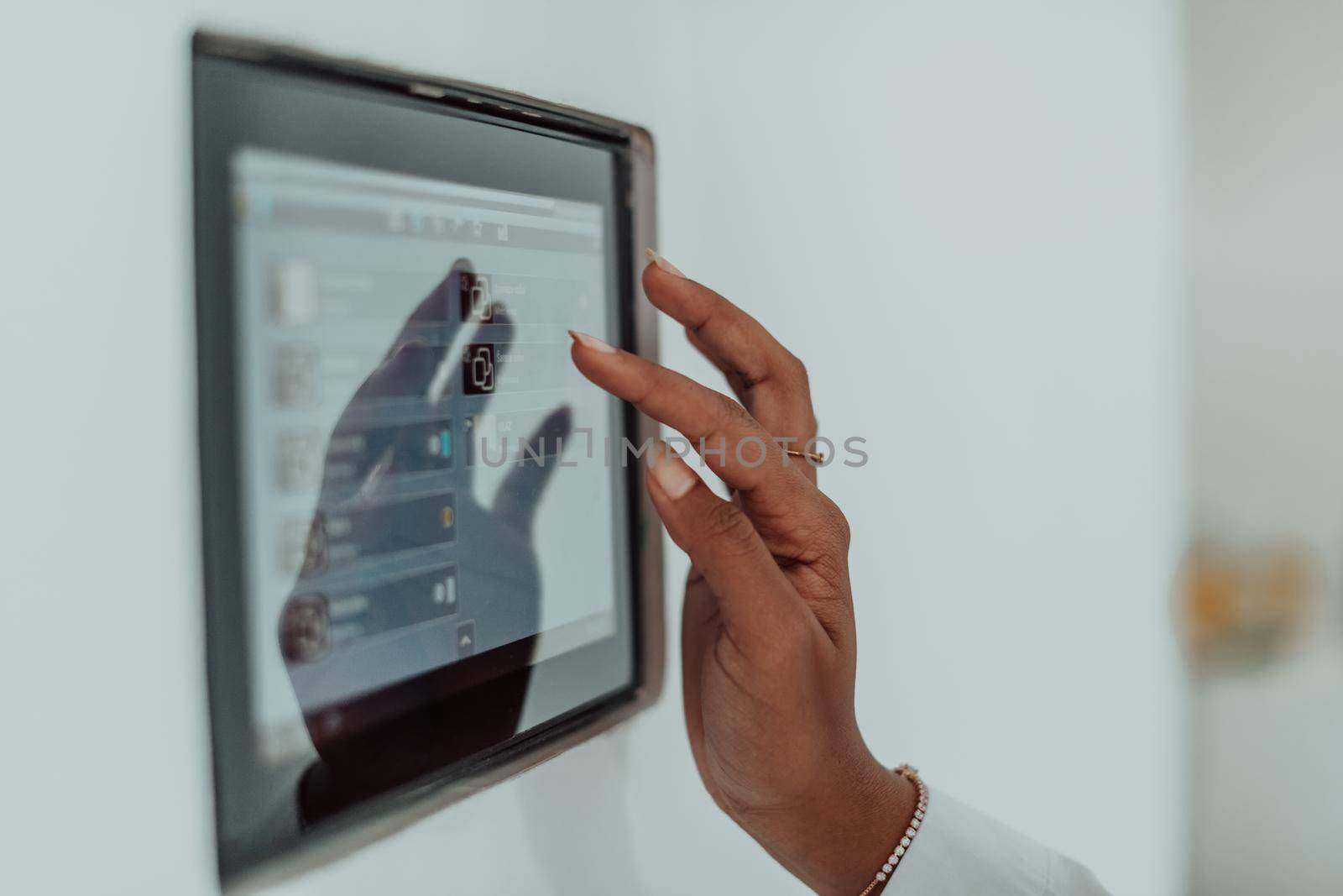 African woman using smart home screen control system by dotshock