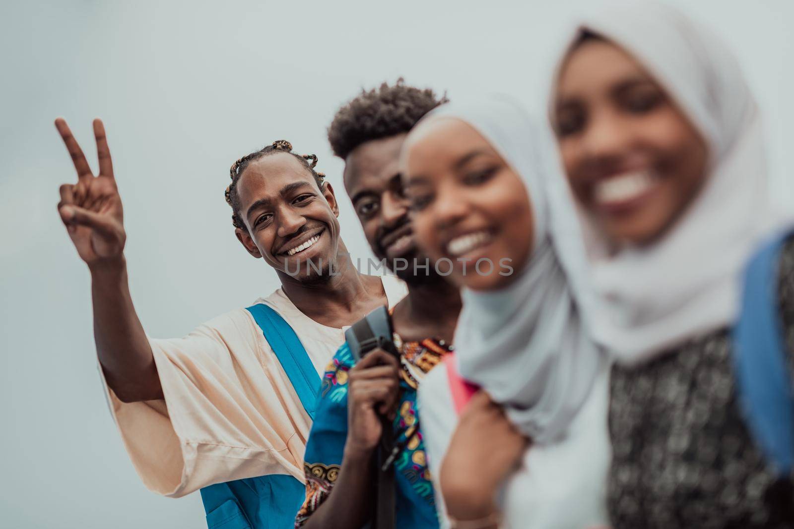 Group of happy African students having a conversation and team meeting working together on homework girls wearing traditional Sudan Muslim hijab fashion. High-quality photo