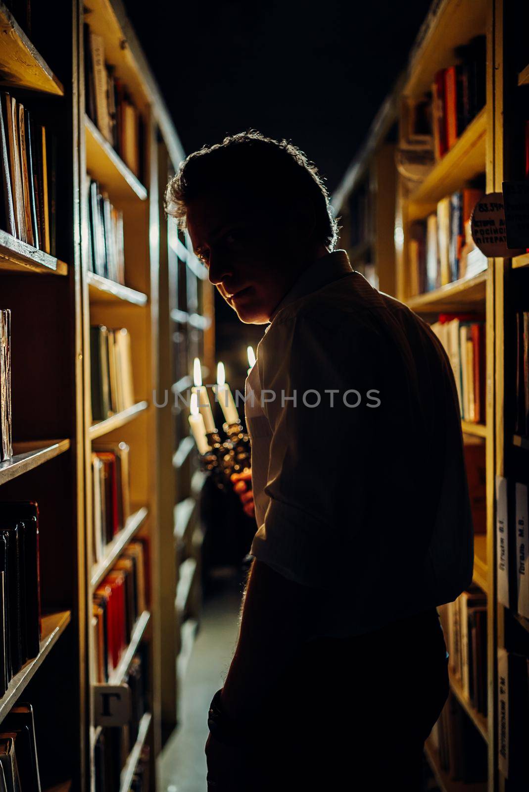 a boy reading in horror library room at school,