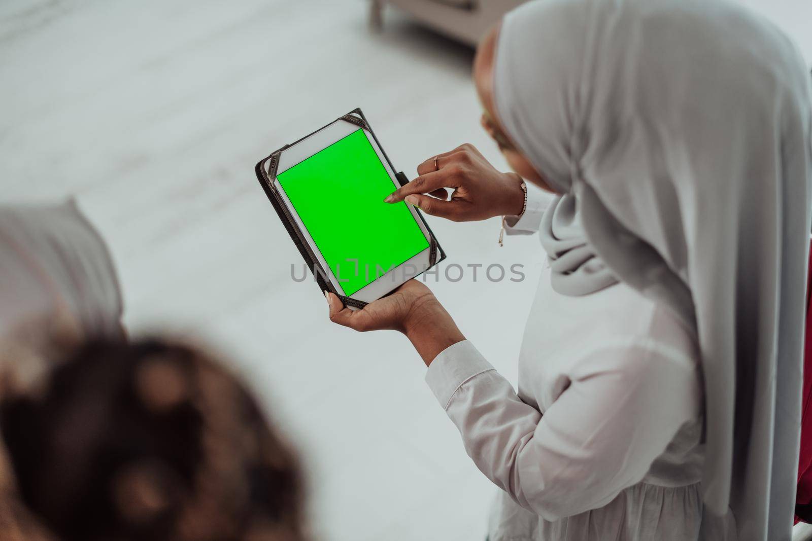 Group of happy african students having conversation and team meeting working together on homework girls wearing traidiional sudan muslim hijab fashion by dotshock