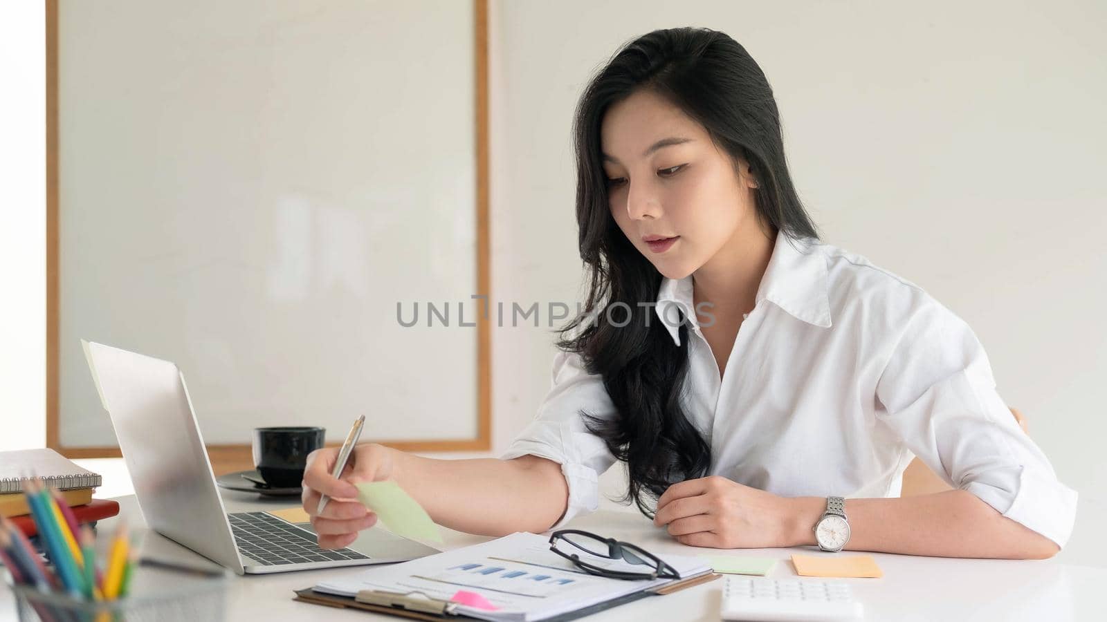 Portrait Of Attractive Asian young business entrepreneur woman working at modern office.