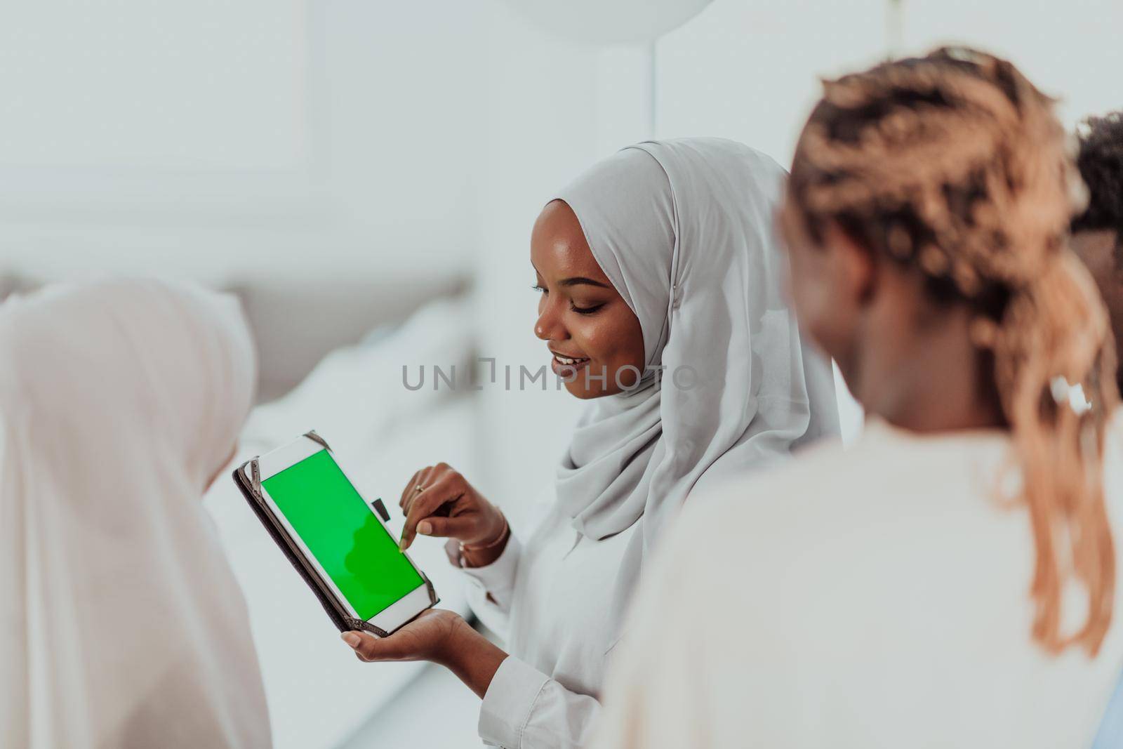 Group of happy african students having conversation and team meeting working together on homework girls wearing traidiional sudan muslim hijab fashion by dotshock