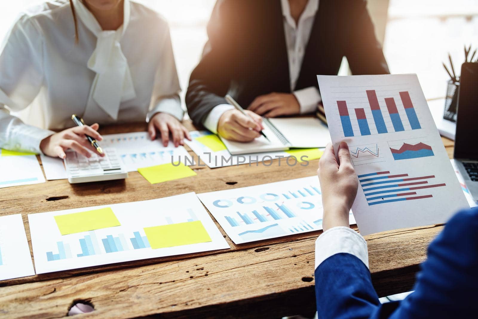 Brainstorming, consultation, data analysis, planning, marketing, accounting, economics, male businessman holding a document to plan and explain investment risks at a meeting. by Manastrong