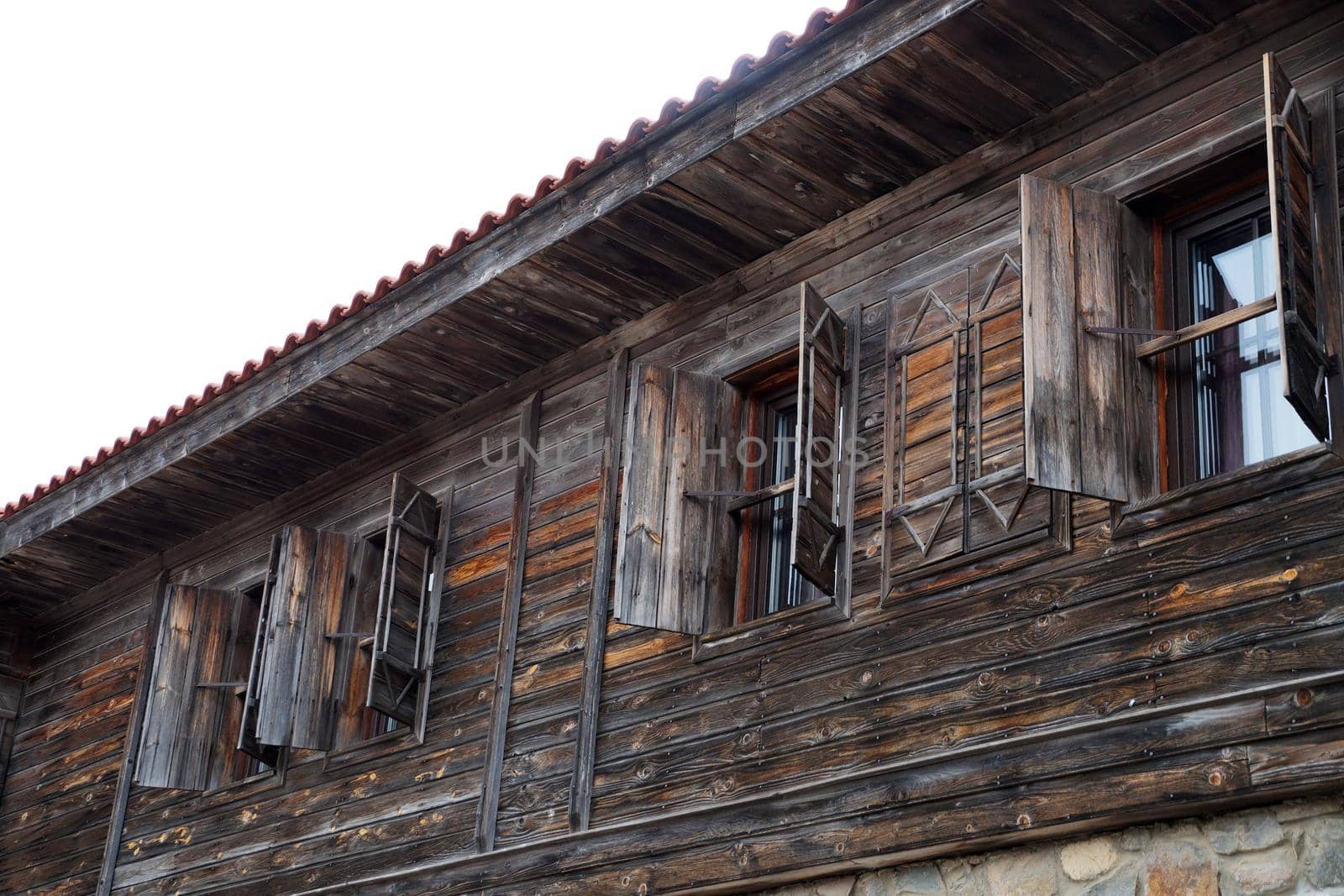 wooden shutters on an old house in the tourist town of Sozopol Bulgaria by Annado