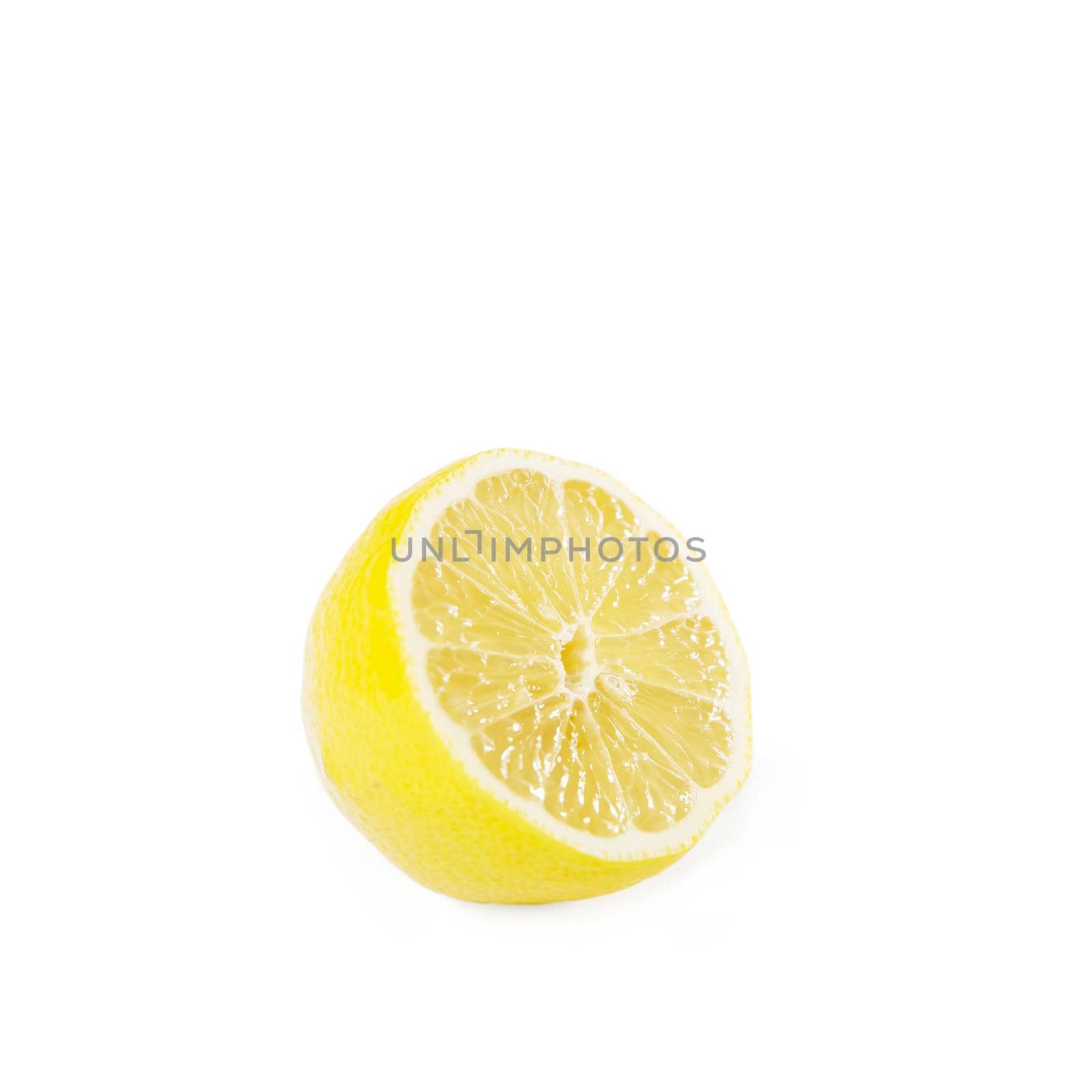 Half sliced lemon is on the white background by elenarostunova