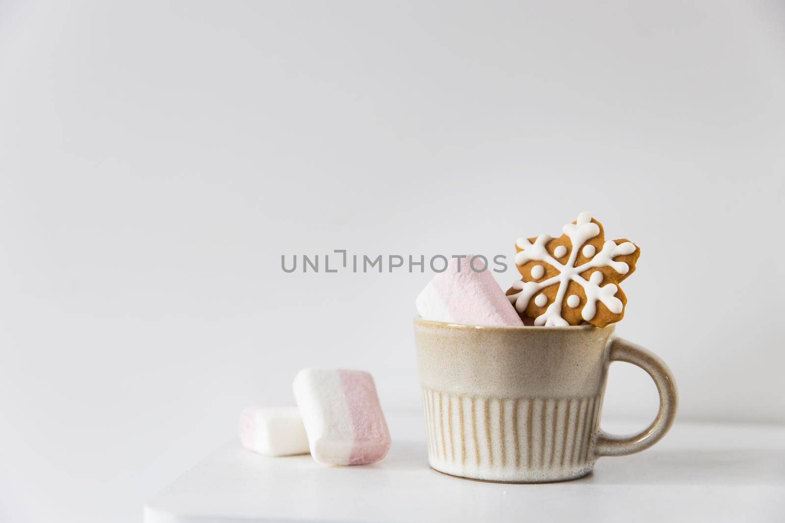 Christmas or New Year composition with cocoa, gingerbread cookies and christmas decorations. Hot chocolate with marshmallows on a white background of table. Copy space. Mock up