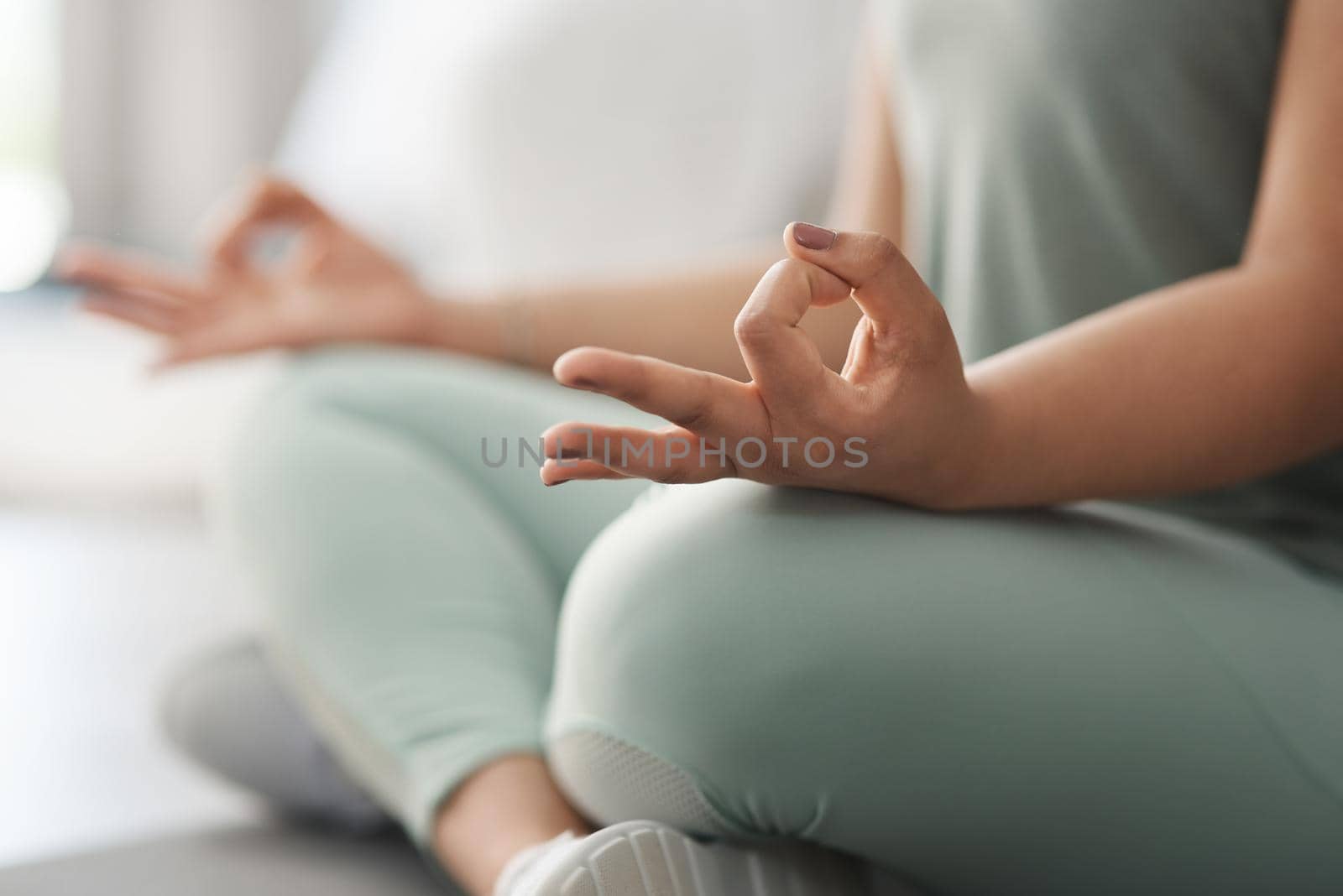 Closeup shot of an unrecognisable woman meditating at home.