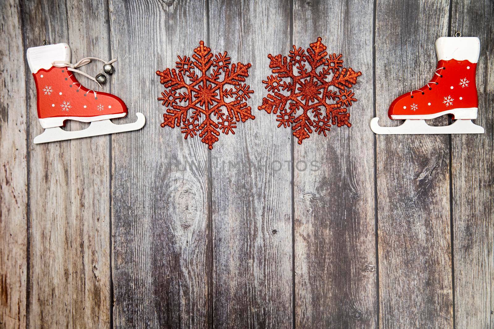Wooden handmade snowflake toys on wooden Christmas background. Beautiful crafts cut from eco friendly wood material. Ecological home decor for winter holiday. Decorate house with natural materials