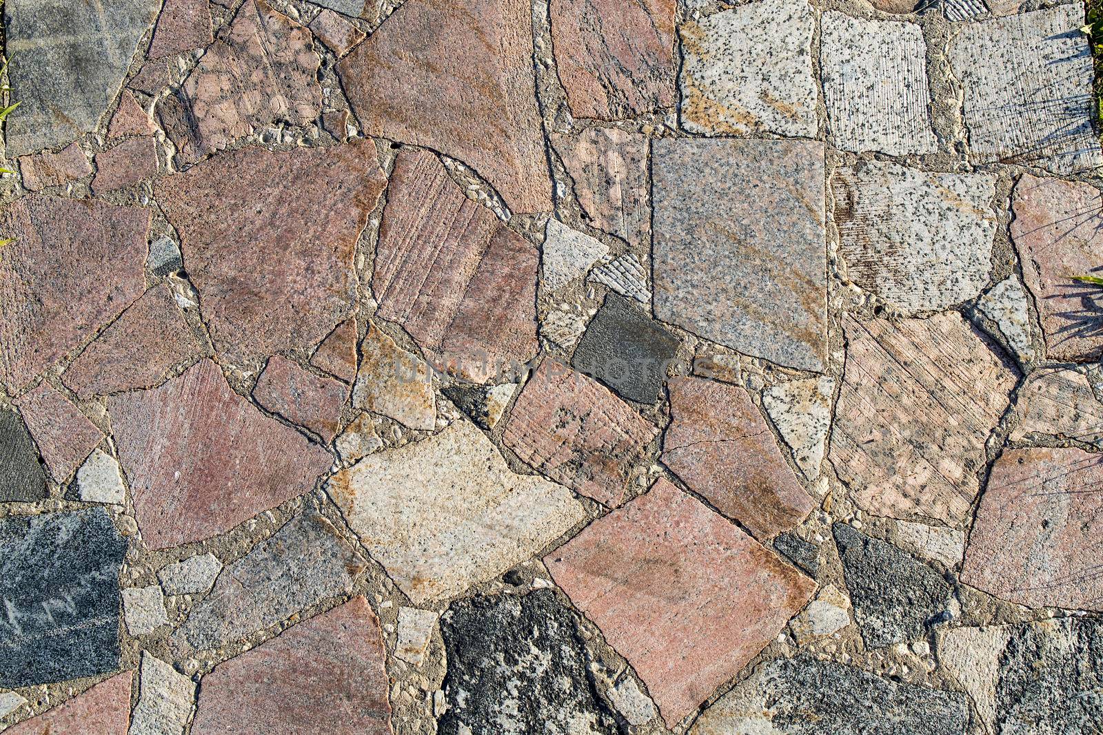 sample of paving stones with decorative unevenly laid stones by elenarostunova