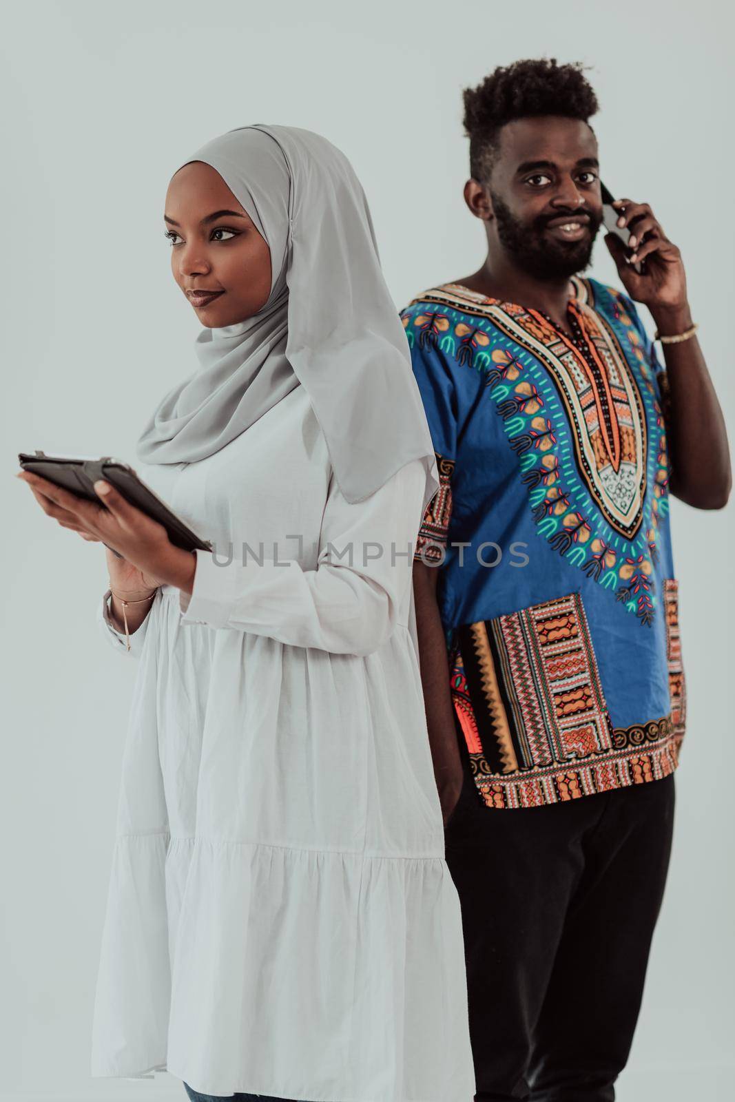 Young African business team woman wearing traditional Sudan Muslim hijab clothes using tablet computer isolated on white background students couple. High-quality photo
