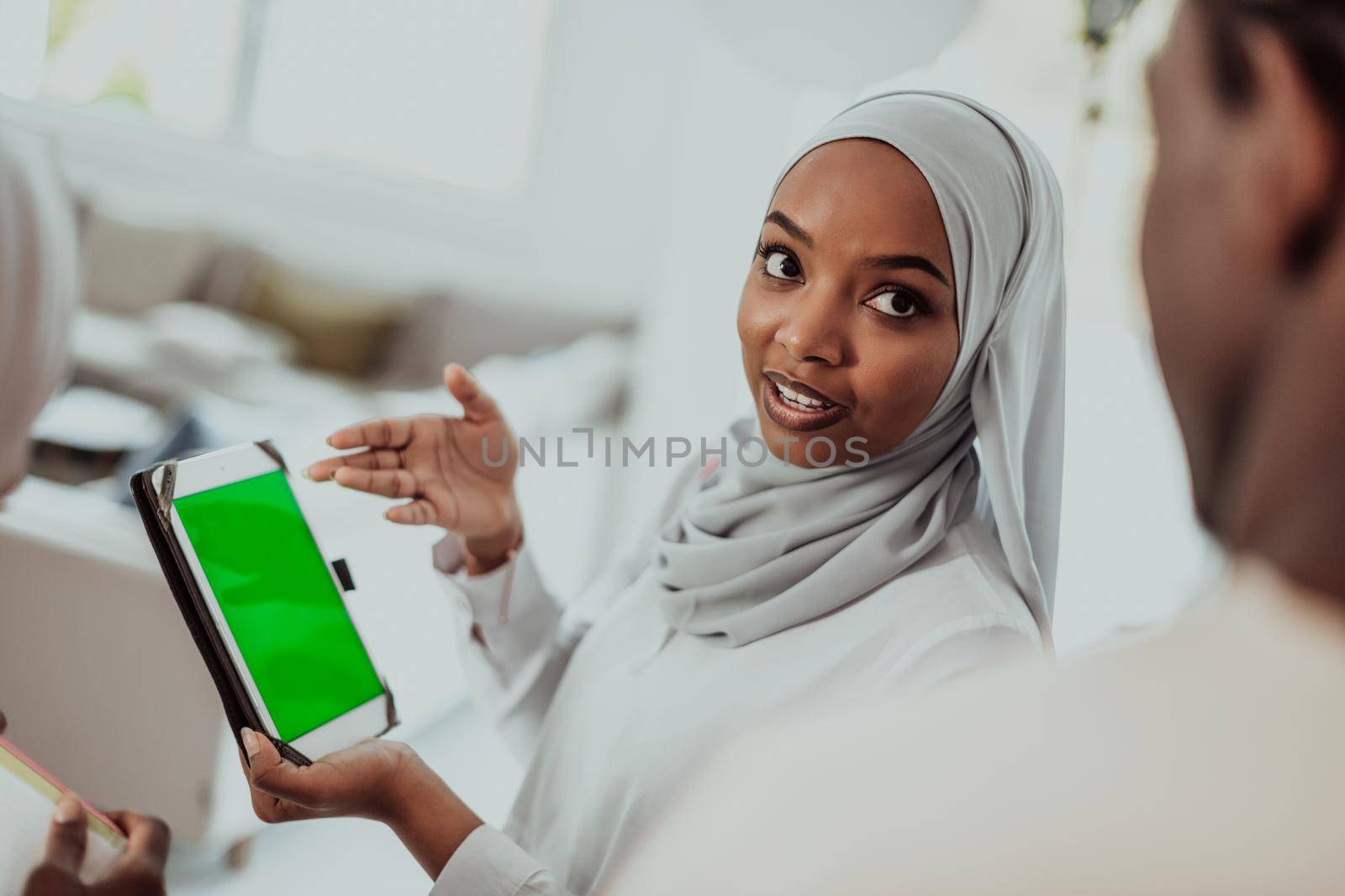 Group of happy african students having conversation and team meeting working together on homework girls wearing traidiional sudan muslim hijab fashion by dotshock