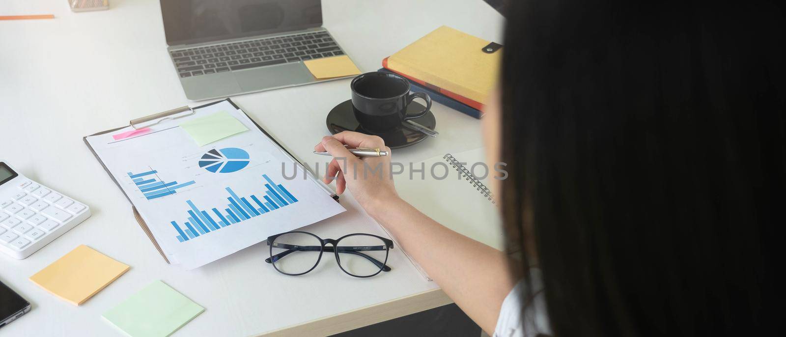 Business woman using calculator for do math finance on wooden desk in office and business working background, tax, accounting, statistics and analytic research concept.