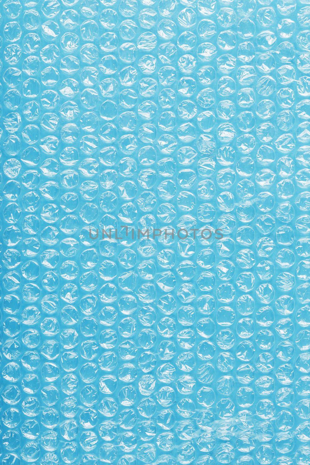The texture of the packaging air-bubble film on a blue background in full screen
