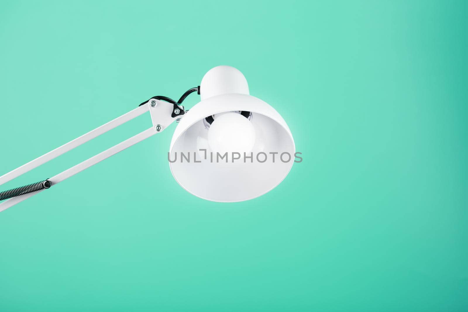 White table office lamp on green background with space for text and idea concept