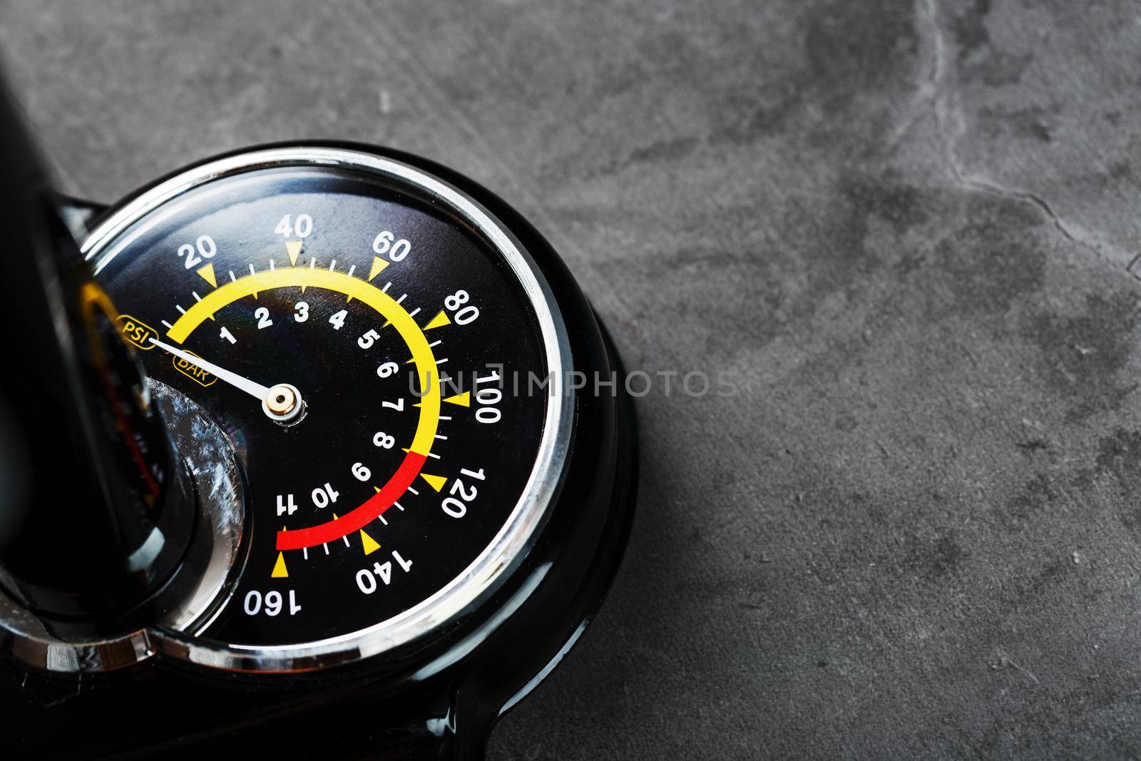 Hand air pump manometer for pressure control on a dark background close-up