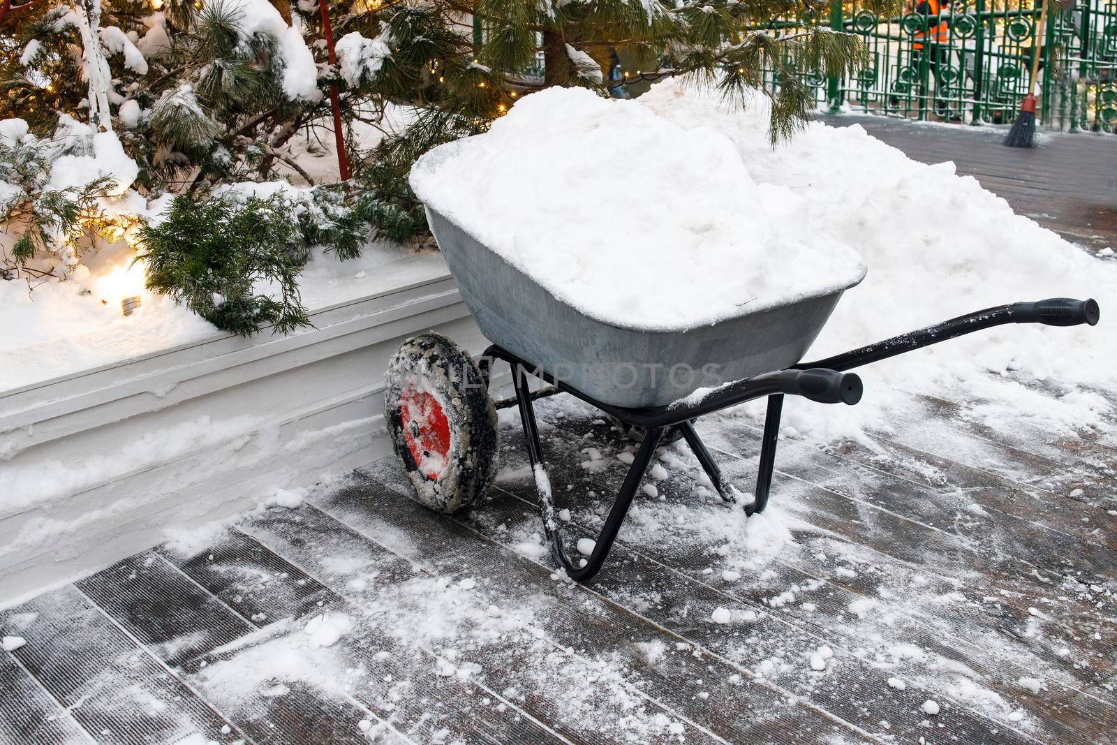 A cart filled with snow is on the street. Cleaning the streets from snow in snowfall.