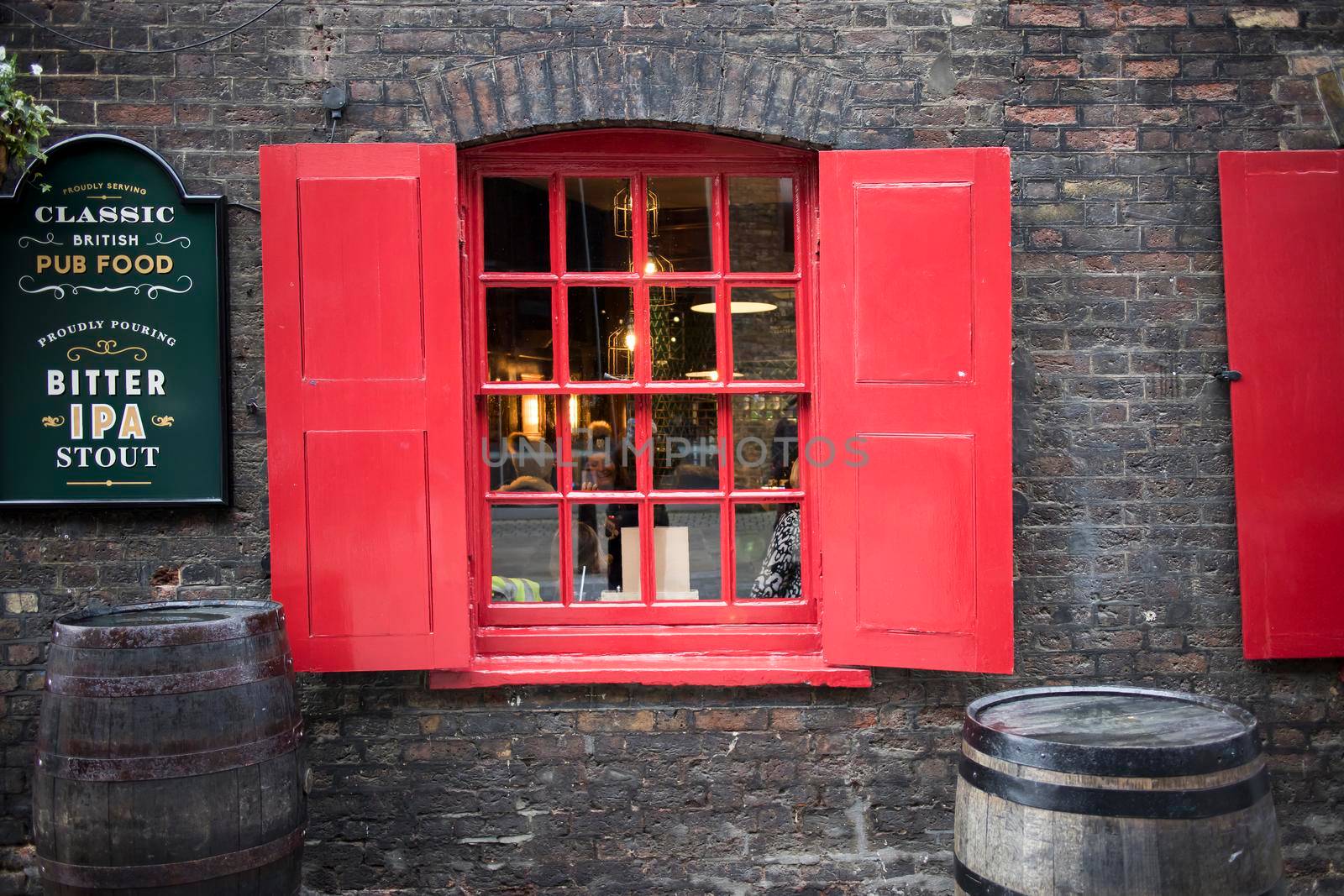 London, UK, - 23 December 2020, LONDON, ENGLAND - December 17, 2020 Window with red shutters, decorated with a drawing with a horse in a traditional Christmas style about the south bank in London