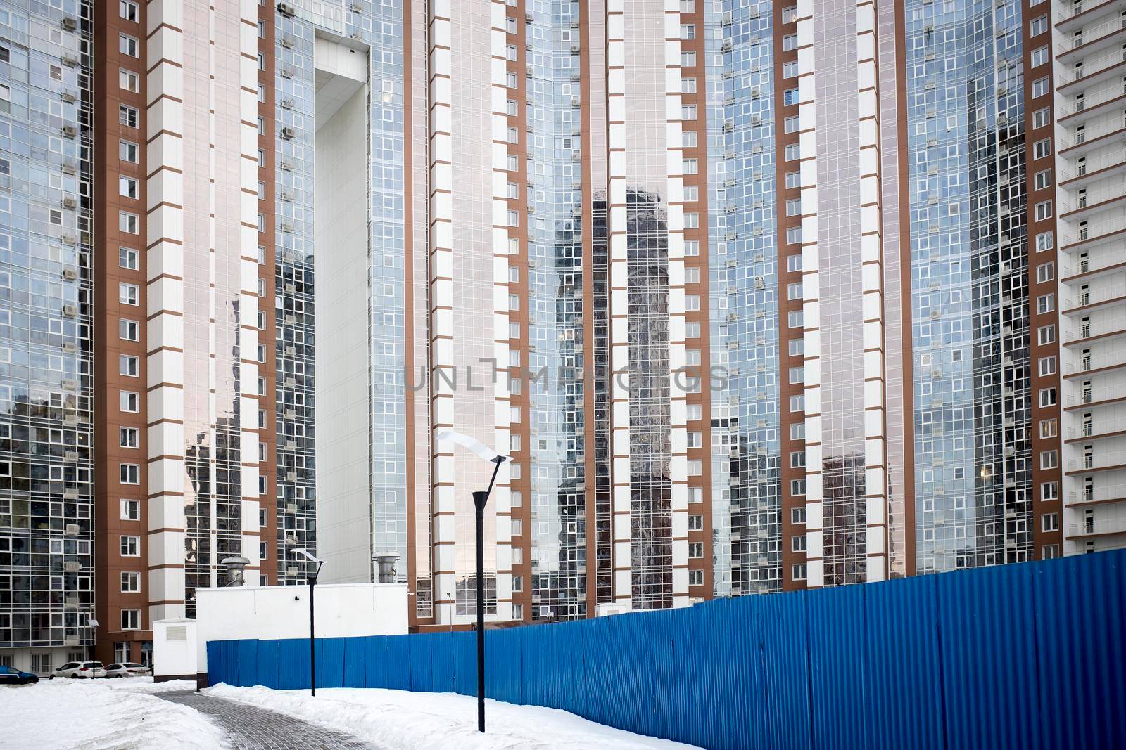 KHIMKI, RUSSIA - February, 2021: View Of the new Khimki . Construction of a new modern district. Moscow region. Blue construction fence and road