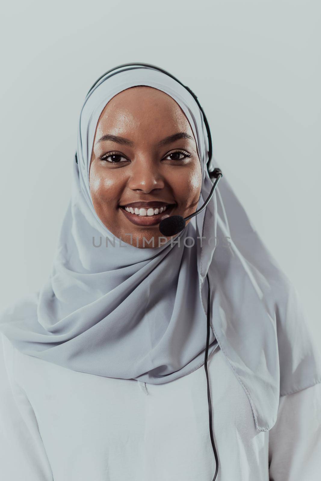 African muslim female with hijab scarf customer representative business woman with phone headset helping and supporting online with customer in modern bright call centre isolated on white background by dotshock