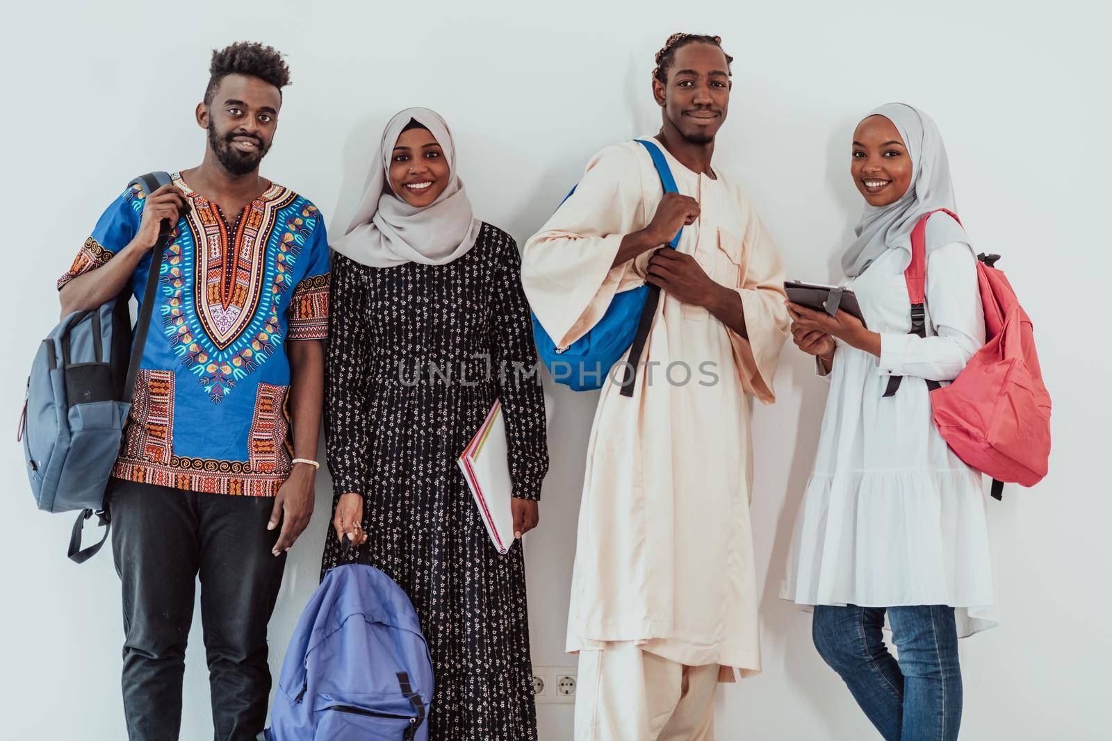 photo of a group of happy African students talking and meeting together working on homework girls wearing traditional Sudanese Muslim hijab. High-quality photo