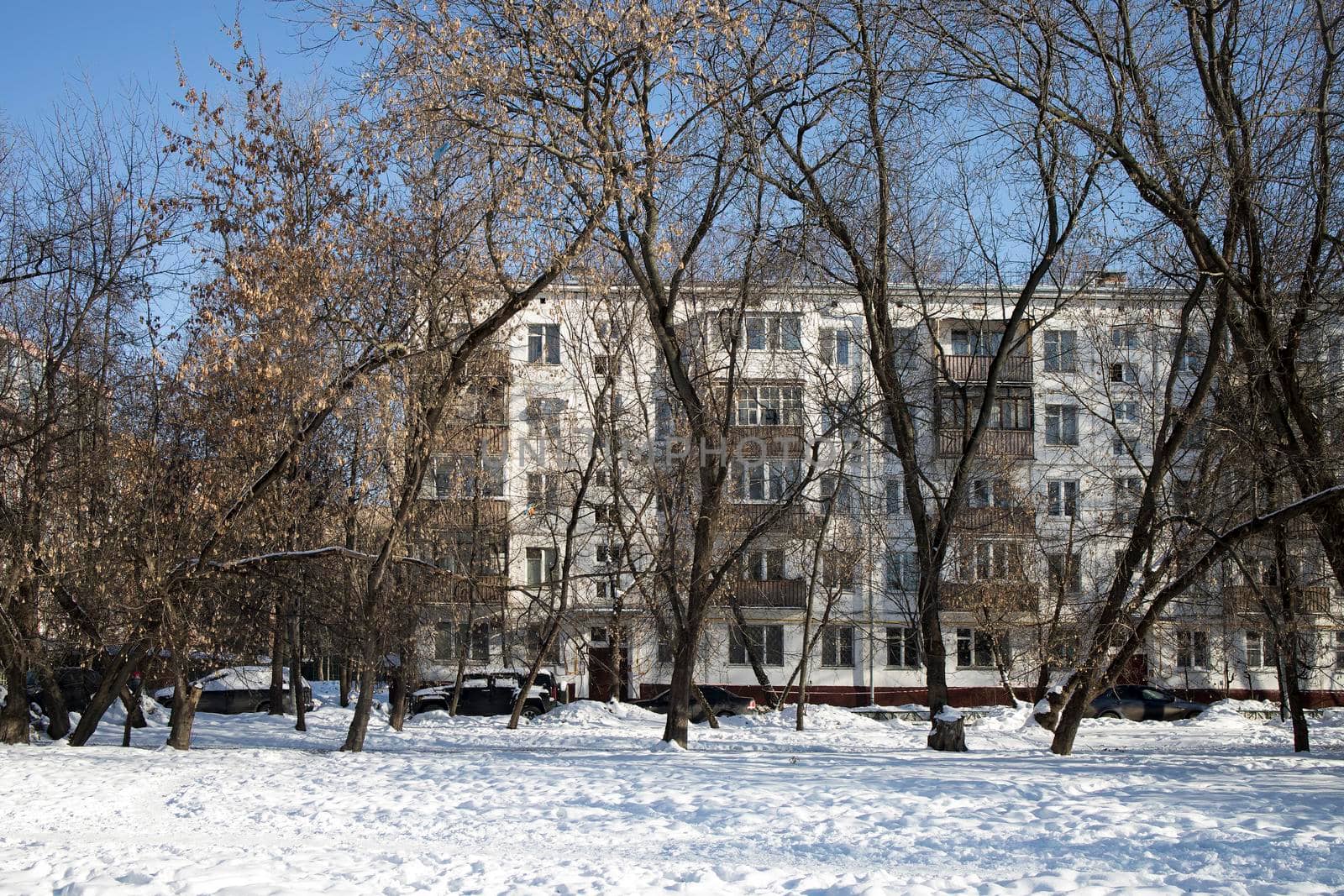 Five-storey block buildings with balconies in the Preobrazhenskaya square, built in the sixties, in good winter weather. by elenarostunova