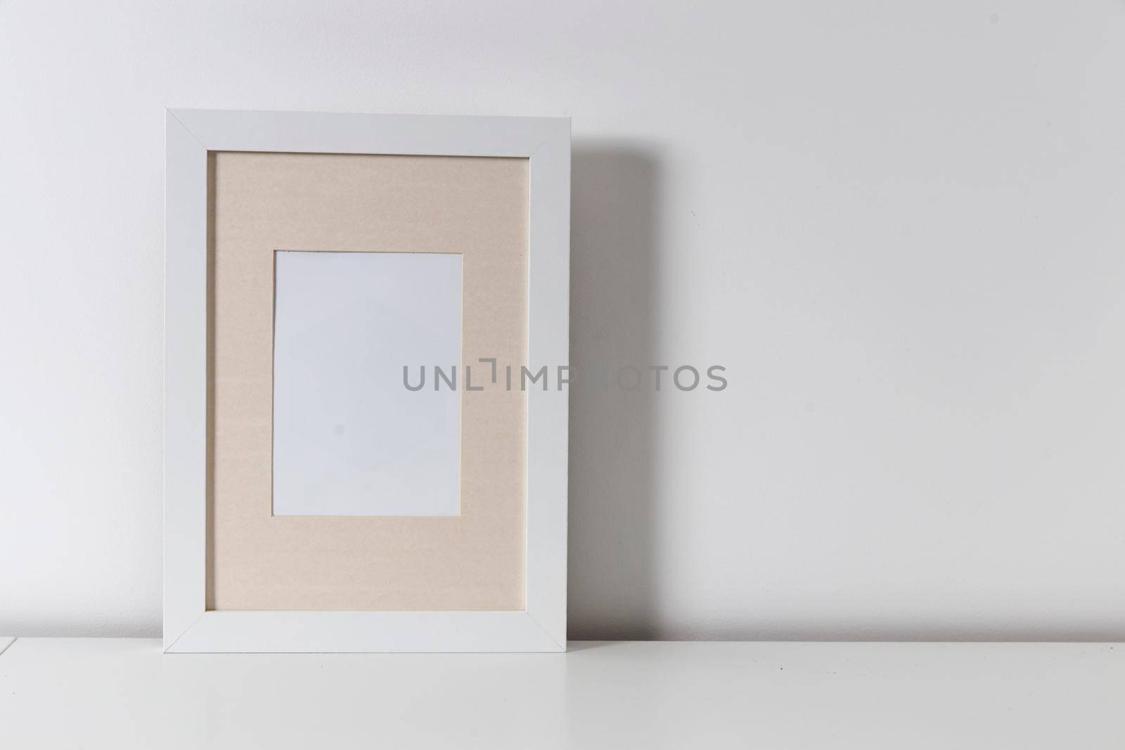 Blank canvas frame mockup. Artwork in interior design. View of modern scandinavian style interior with canvas for painting or poster on wall. Living room, commode with vases. Minimalism concept