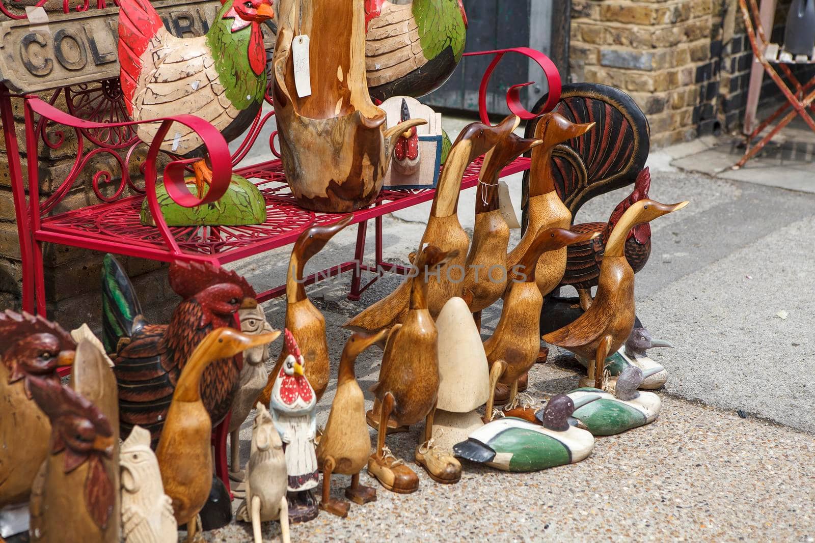 Wooden geese and ducks for sale at the entrance to the store by elenarostunova