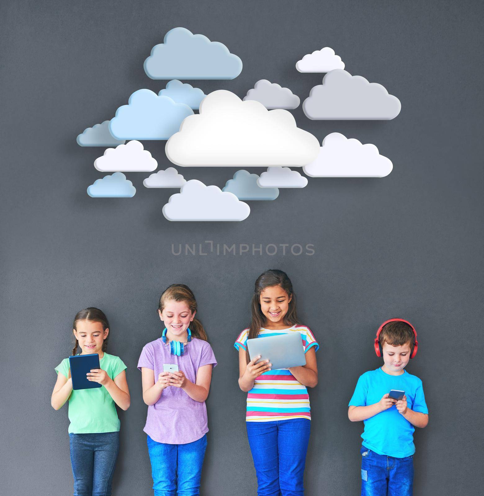 Kids keeping connected. Studio shot of kids using wireless technology with clouds above them against a gray background. by YuriArcurs