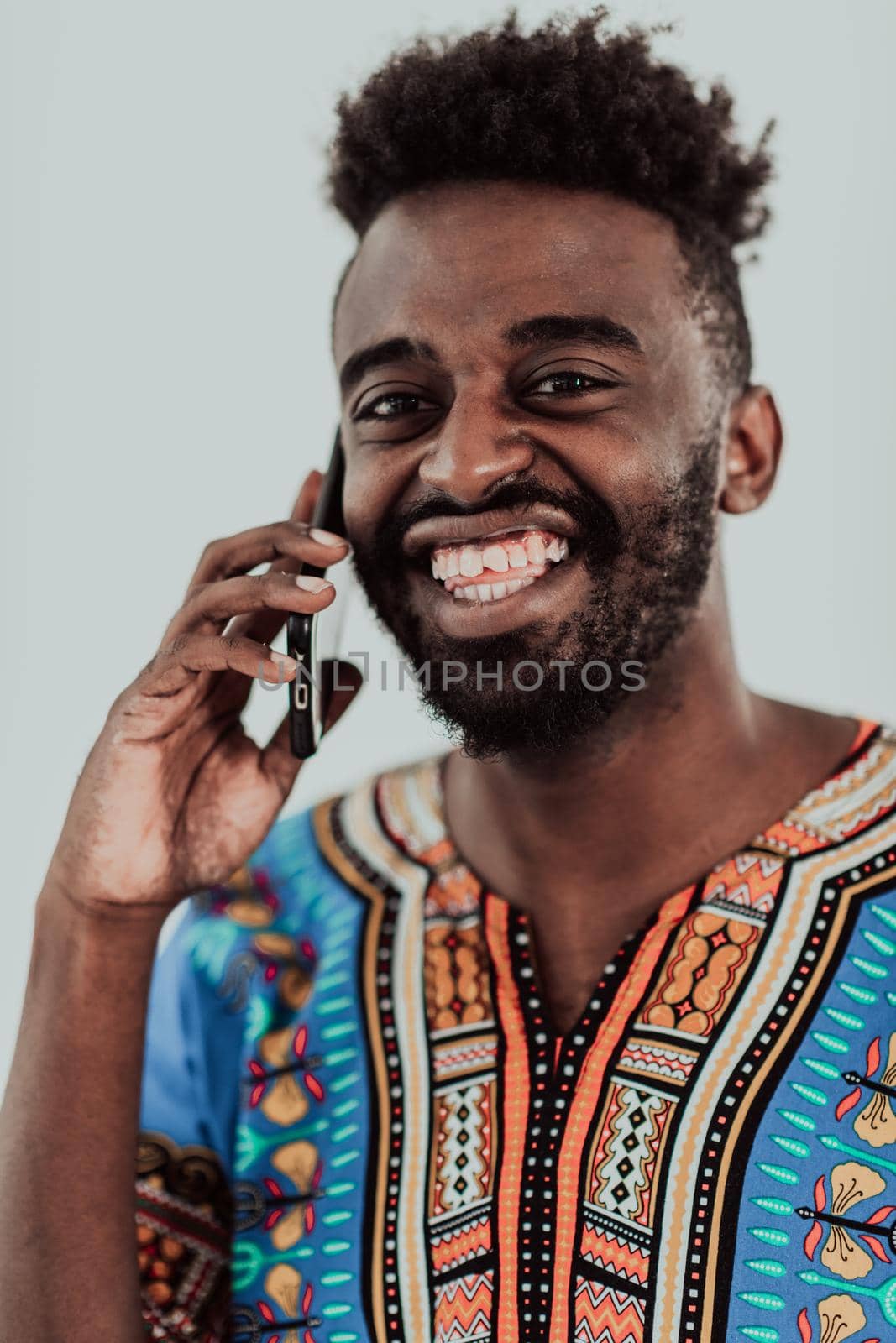 Native Sudan African male using smartphone isolated on white background. by dotshock