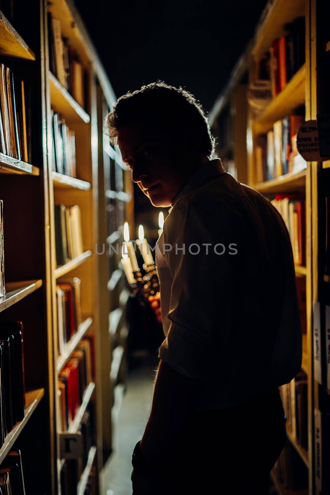 a boy reading in horror library room at school by mosfet_ua