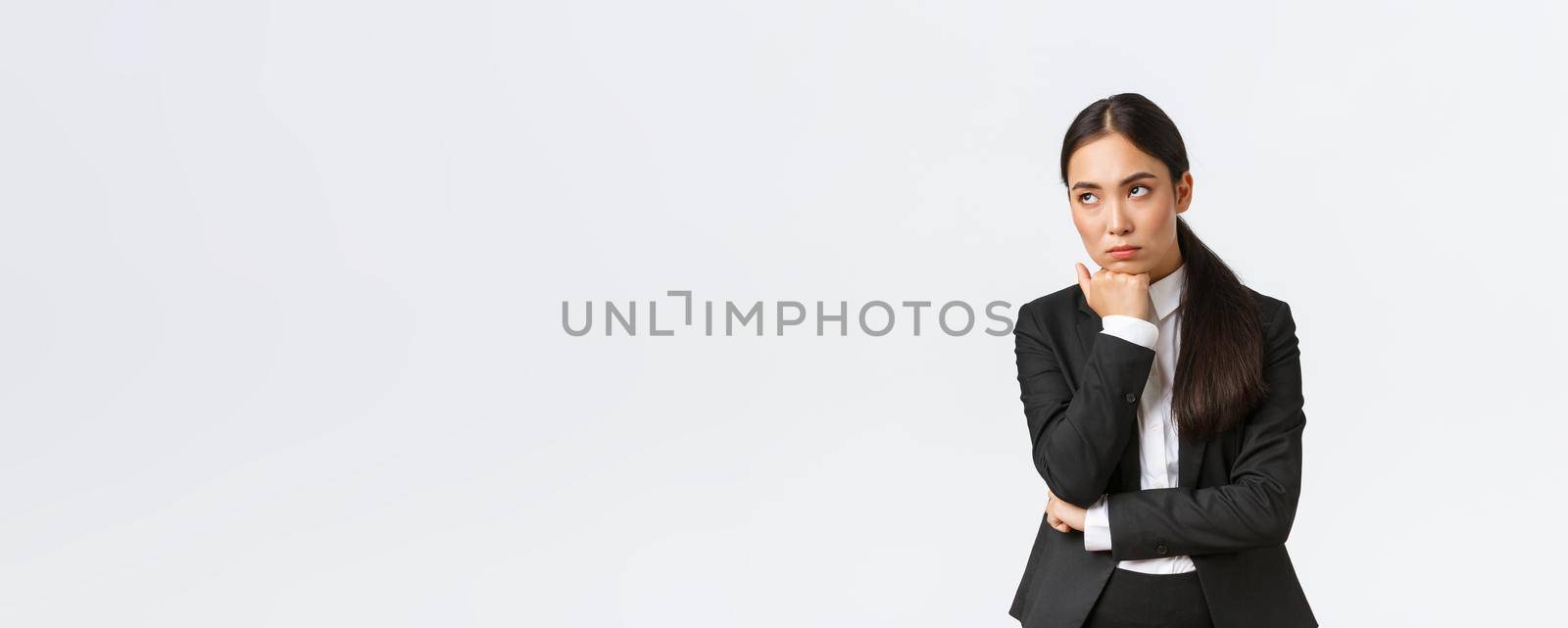 Bored and annoyed female entrepreneur looking unamused away while sitting boring meeting, attend uninteresting office gathering, standing white background dying boredom.