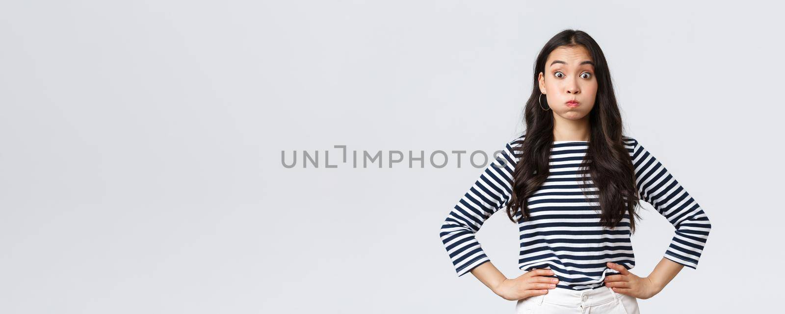 Lifestyle, people emotions and casual concept. Confused cute and puzzled girl pouting, searching for solution, holding breath and staring questioned camera, white background by Benzoix