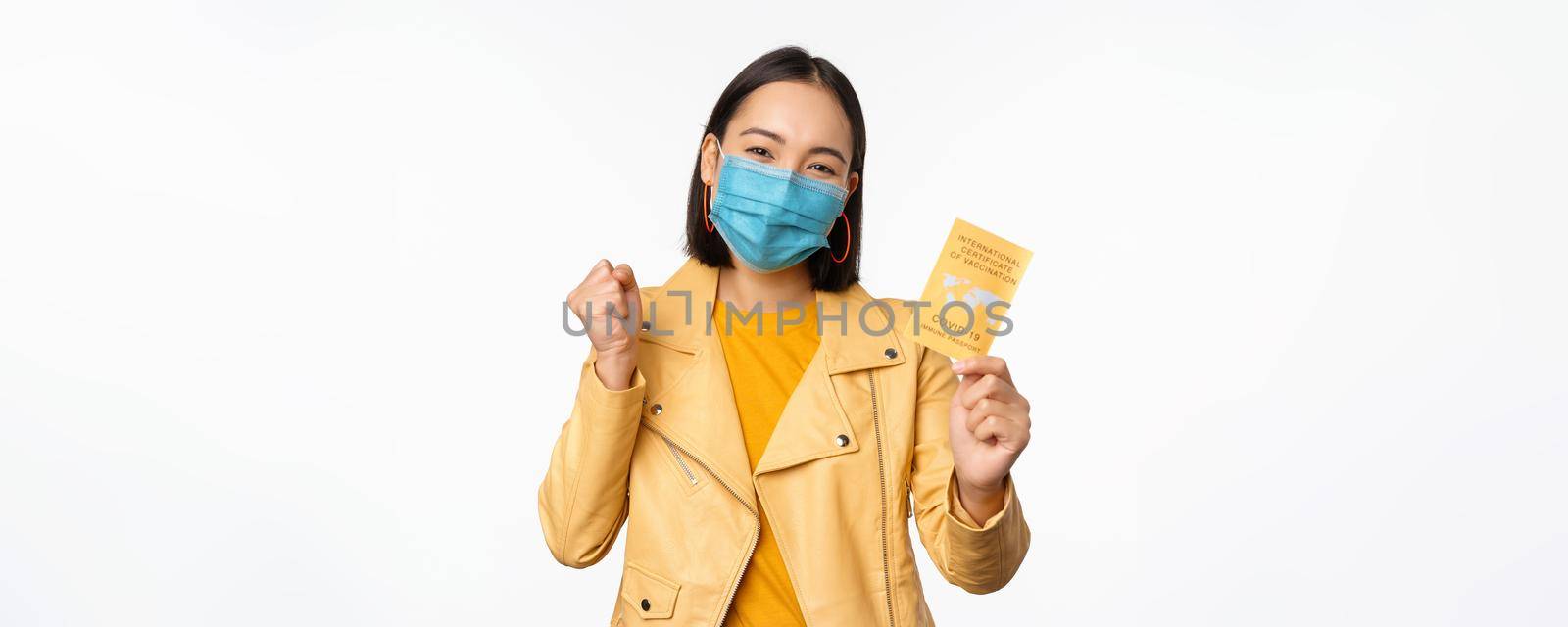 Hey you got point. Cheerful cute asian lively girl dark short haircut pointing camera finger-pistol smiling broadly, encourage friend make move, congratulate coworker good job, stand blue background by Benzoix