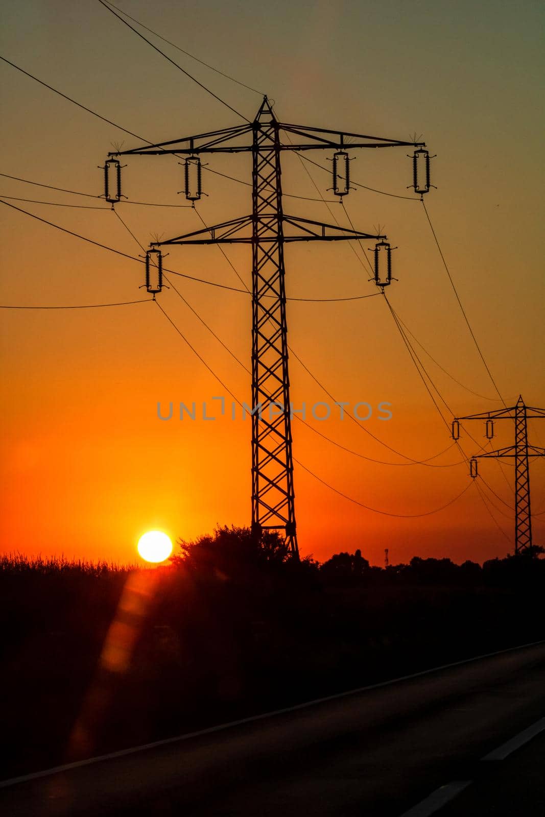 Electric power pylon, electric tower at sunset by vladispas