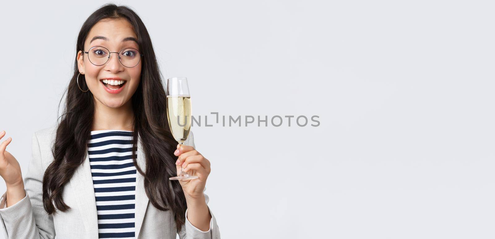 Business, finance and employment, female successful entrepreneurs concept. Enthusiastic happy businesswoman celebrating good deal, have office party with coworkers, make toast with glass champagne.