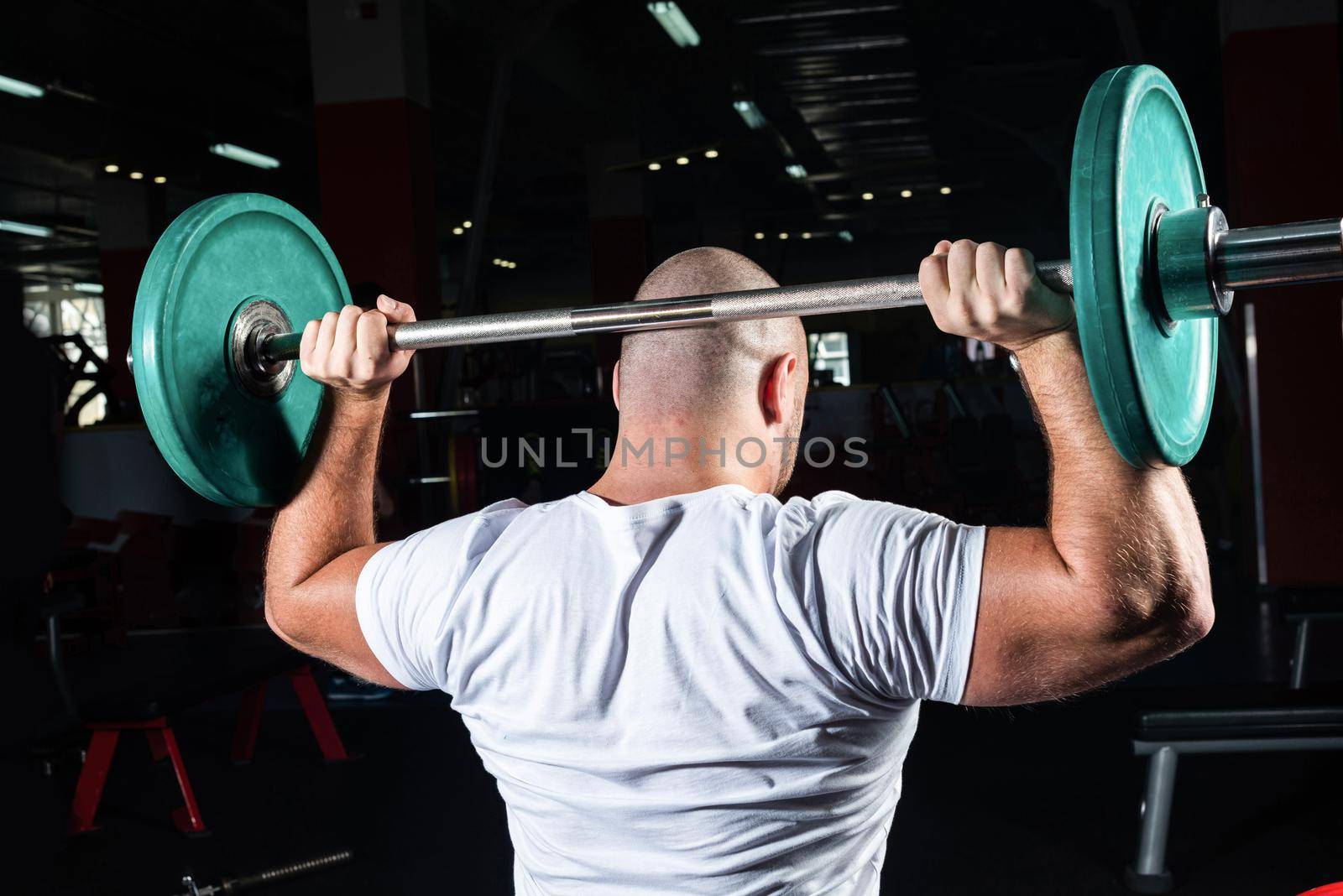 Man in the gym lifts the barbell. bodybuilding and healthy lifestyle