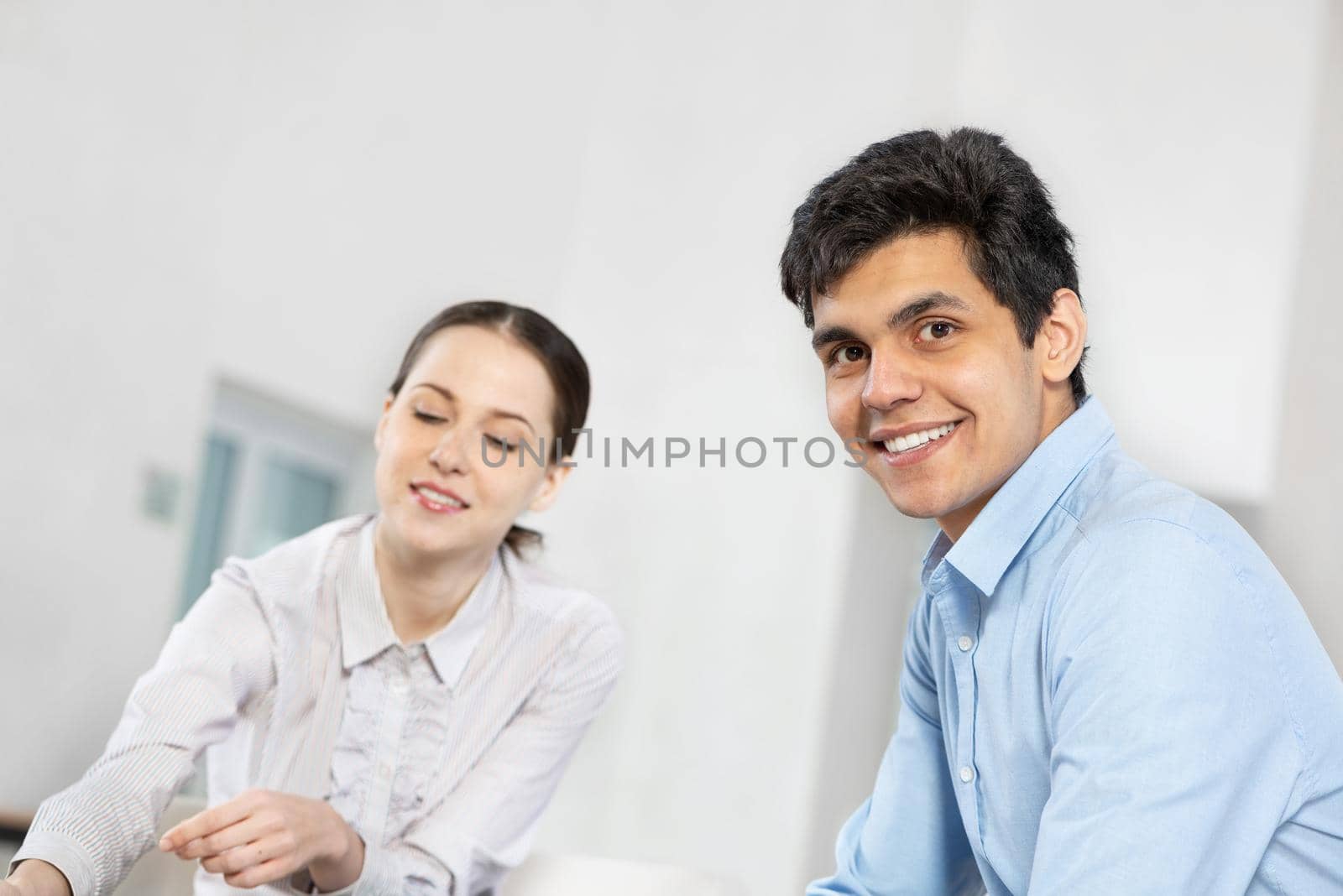 portrait of a young man at a business meeting. concept of team work